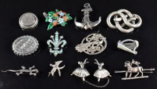 A collection of brooches including two Victorian silver, one with applied gold decoration, Victorian