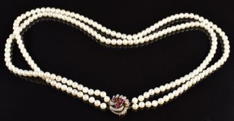 A double strand of cultured pearls, the 9ct gold clasp set with rubies and diamonds, 56cm long, 43g