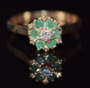A 9ct gold ring set with a diamond and emeralds, 2.5g, size P
