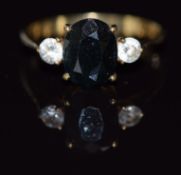 A 9ct gold ring set with an oval cut sapphire and cubic zirconia, 1.9g, size N