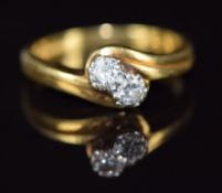An 18ct gold ring set with two diamonds in a twist setting, 4.8g, size N