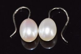 A pair of 18ct white gold earrings set with a pearl to each, the pearls approximately 1.2cm