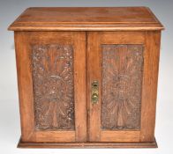 A carved oak smoker's cabinet with fitted interior, W28 x D19 x H26cm
