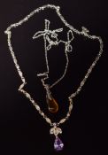 Two silver necklaces, one set with amber the other paste