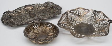 Three various hallmarked silver pierced dishes, two with embossed decoration, length of longest 18.