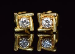 A pair of 18ct gold earrings set with a diamond of approximately 0.15ct to each, 2.4g