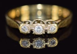 An 18ct gold ring set with three diamonds, 3.2g, size N