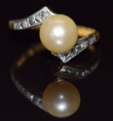 An 18ct gold ring set with a pearl and diamonds in a platinum setting, 3.9g, size N