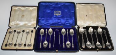 Three cased sets of hallmarked silver coffee or teapoons comprising Asprey coffee bean spoons,