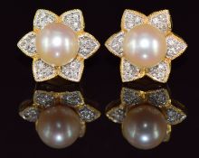 A pair of 18ct gold earrings set with a pearl surrounded by diamonds in a floral setting, 5.3g