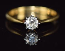 An 18ct gold ring set with a diamond of approximately 0.25ct in a platinum setting, 2.1g, size M