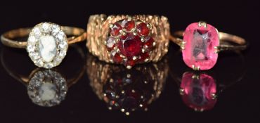 Three 9ct gold rings, one set with garnets, 8.5g