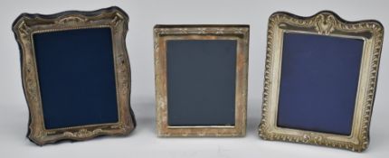 Three hallmarked silver photograph frames, all to suit 6 x 4 inch photo and with easel backs,