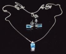A 9ct white gold pendant and earrings set with emerald cut blue topaz and diamonds, 2.6g