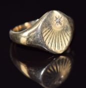 A 9ct gold signet ring set with a diamond in a star setting, 8.9g, size T