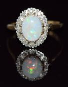 A 9ct gold ring set with an opal and diamonds, 3.3g, size M