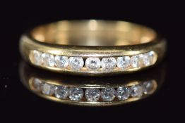 A 14k gold ring set with nine round cut diamonds, 2.7g, size P