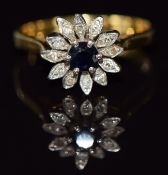 An 18ct gold ring set with a sapphire and diamonds in a cluster, 3.7g, size O