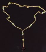 A 9ct gold necklace set with garnet, peridot and quartz, 5g
