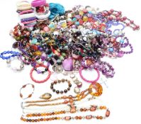 A collection of costume jewellery including beads, mother of pearl necklace, tiger's eye pendant,