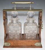 Betjemann's patent oak two bottle tantalus, with cut glass decanters, W27 x H30cm