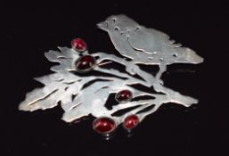 A silver brooch in the form of a bird set with garnet cabochons, maker's mark to verso, 7.5 x 5cm