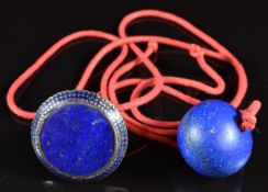 A silver ring set with lapis lazuli and blue enamel together with a lapis lazuli bead