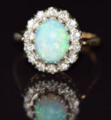 A 14k gold ring set with an opal cabochon surrounded by diamonds, 4.8g, size Q