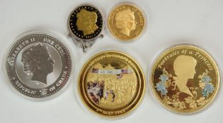 Five embellished commemorative coin medallions including three oversized examples