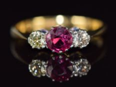 A c1920 18ct gold ring set with a ruby of approximately 0.4ct and diamonds in a platinum setting,