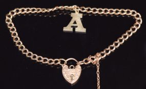 A 9ct rose gold curb link bracelet with yellow metal letter A charm and 9ct gold heart padlock