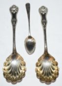 Pair of hallmarked silver serving spoons with shell shaped bowls, import marks for Glasgow 1897,