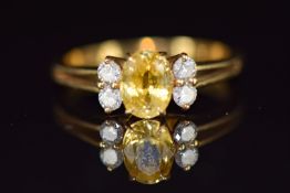 French 18ct gold ring set with a yellow sapphire of approximately 0.65cts and four diamonds, 2.9g,