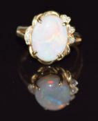 A 14k gold ring set with an opal cabochon and diamonds, 4.2g, size N