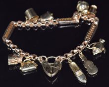 Victorian 9ct gold charm bracelet made up of faceted links with nine 9ct gold charms and heart