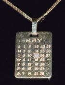An 18ct gold calendar pendant set with a diamond over the 17th May (6.4g, 3 x 1.7cm) on yellow metal