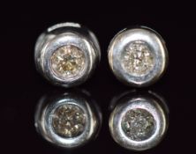A pair of 18ct white gold earrings set with a diamond of approximately 0.05ct to each, 0.8g