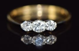 An 18ct gold ring set with three diamonds, 2.3g, size R