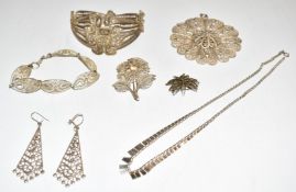 A collection of filigree jewellery including bangle, pendant, brooch, etc