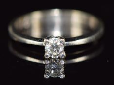 An 18ct white gold ring set with a round cut diamond of approximately 0.19ct, 2g, size K