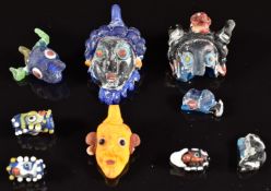 A collection of 19thC Venetian glass face beads, largest 4cm