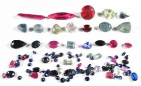 A collection of loose sapphires, tanzanites, rubies, synthetic rubies and an aquamarine