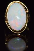 An 18ct gold ring set with an opal cabochon, 5.7g, size K