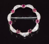 A platinum brooch set with rubies and diamonds, 6.3g, 2.7cm