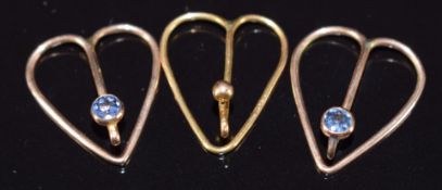A 9ct gold heart shaped clip (0.5g) and two yellow metal tie/ collar clips set with a Montana