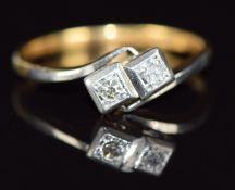 An 18ct gold ring set with two diamonds in a square platinum settings, 2.1g, size L