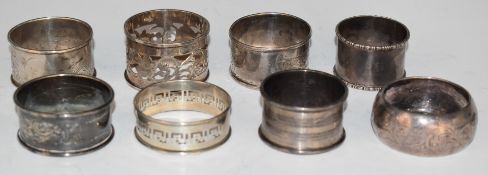 Eight silver napkin rings comprising seven various hallmarked examples and a Chinese example, weight