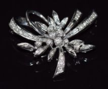 An 18ct white gold brooch set with diamonds in a stylised floral design, 11.5g, 3.5cm