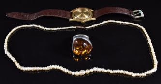 A silver ring set with a pressed amber cabochon, Accurist watch and natural pearl necklace with