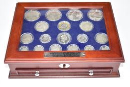 The House of Windsor Silver Coin Collection by Danbury Mint, in deluxe wooden collector's cabinet,